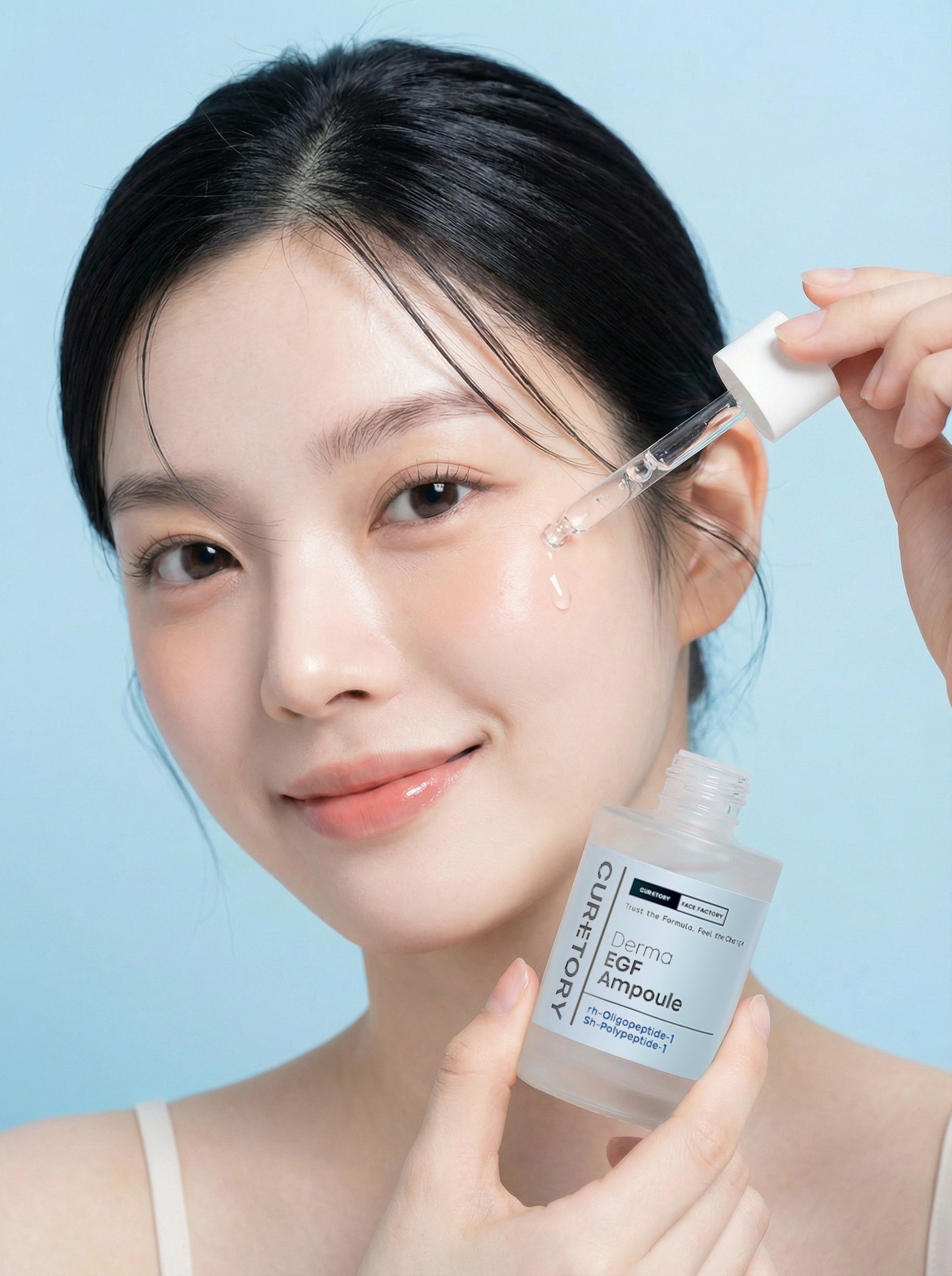 Model applying Face Factory Derma EGF Ampoule serum with a dropper