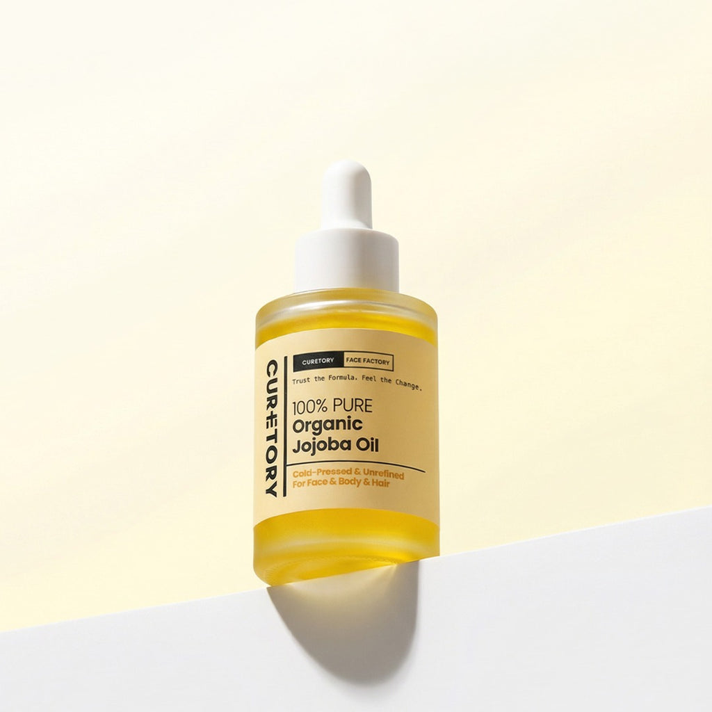 Bottle of Face Factory's 100% Pure Organic Jojoba Oil on a light yellow background