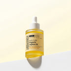 Bottle of Face Factory's 100% Pure Organic Jojoba Oil on a light yellow background