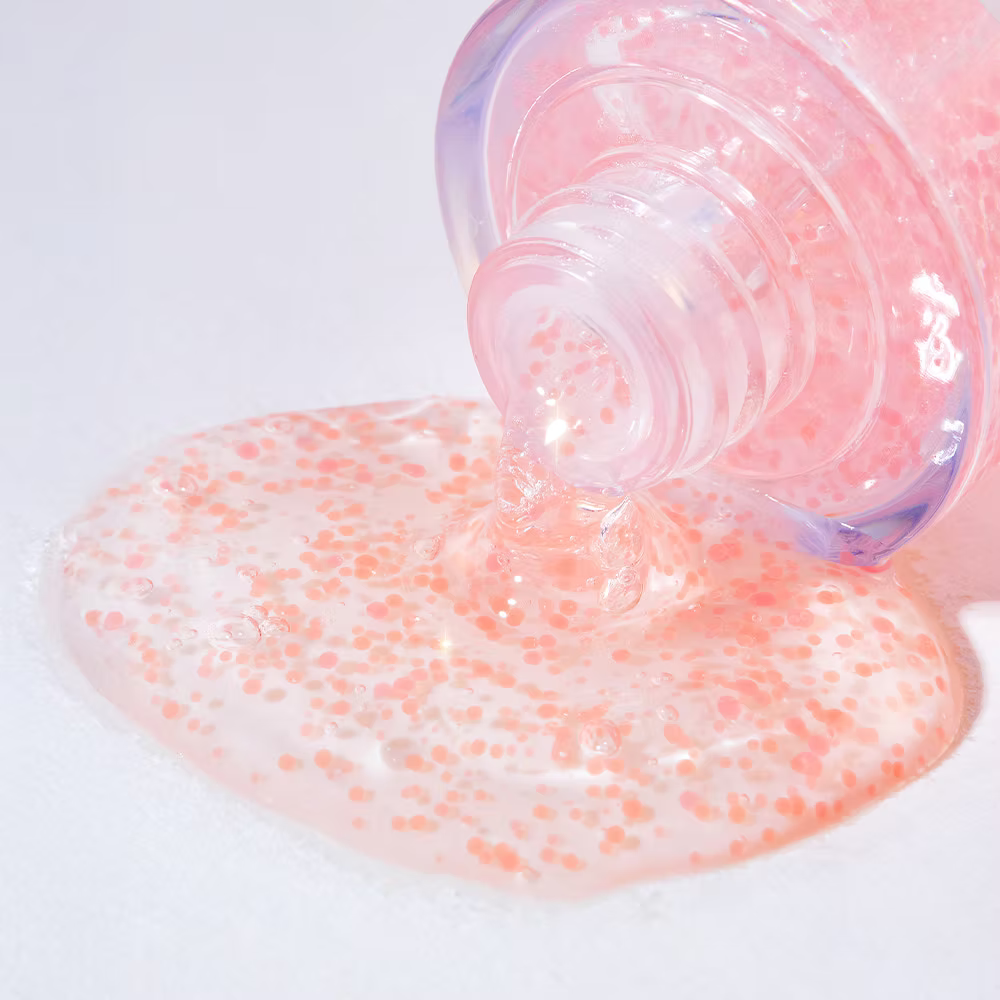 Pink Tomato Brightening Ampoule gel texture with visible pink capsules